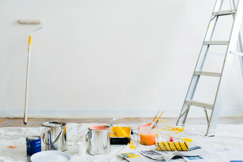 Buckets of paint and ladder on the floor