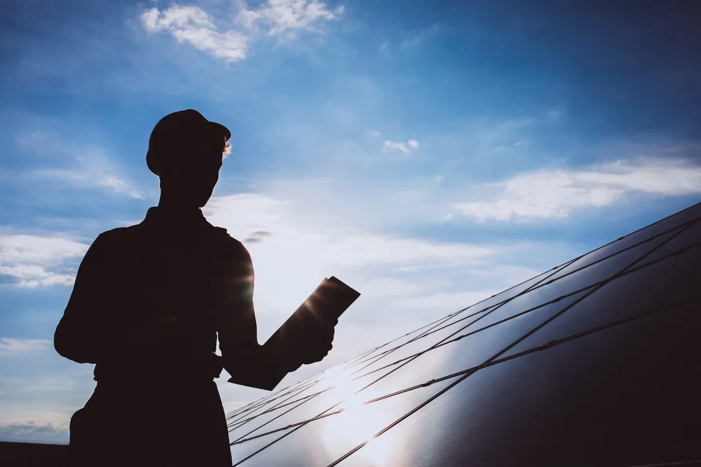 man worker in the field by the solar panels