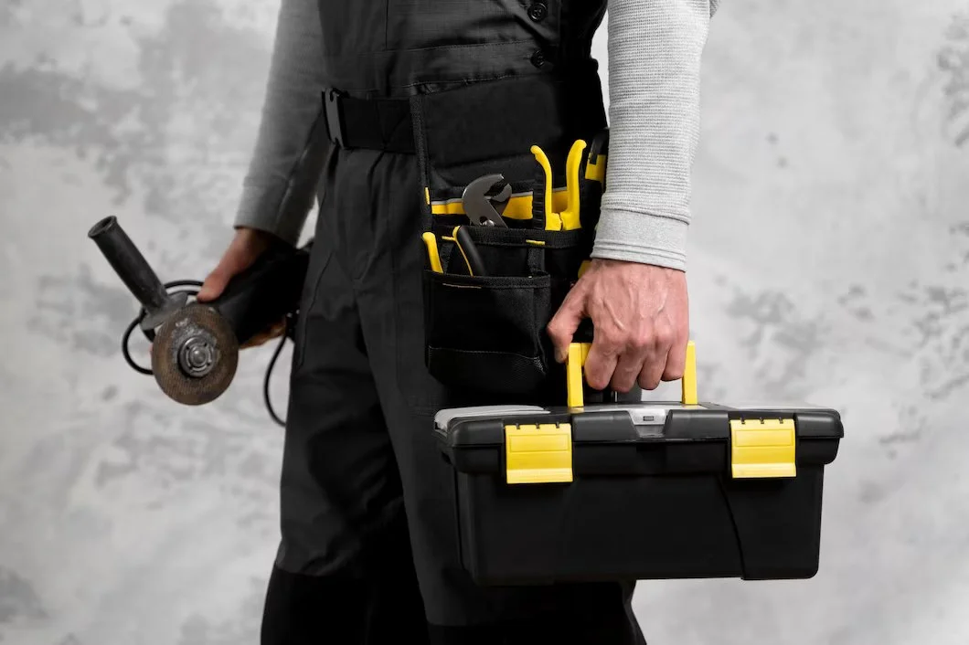 service and maintenance worker holding tool box