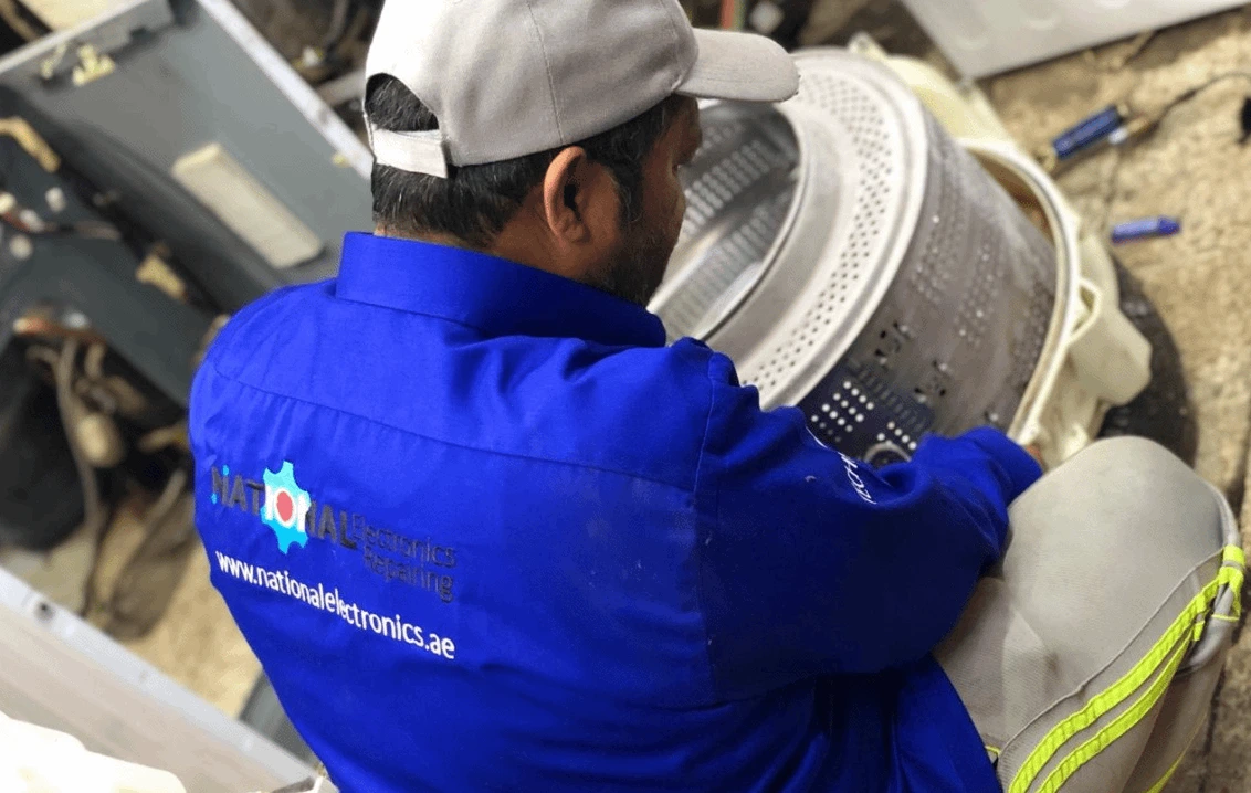 Man repairing a washing machine